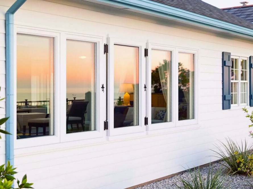Durable, stylish windows facing a sunset ocean view show the importance of smart window choices for coastal homes to withstand salt air and storms.